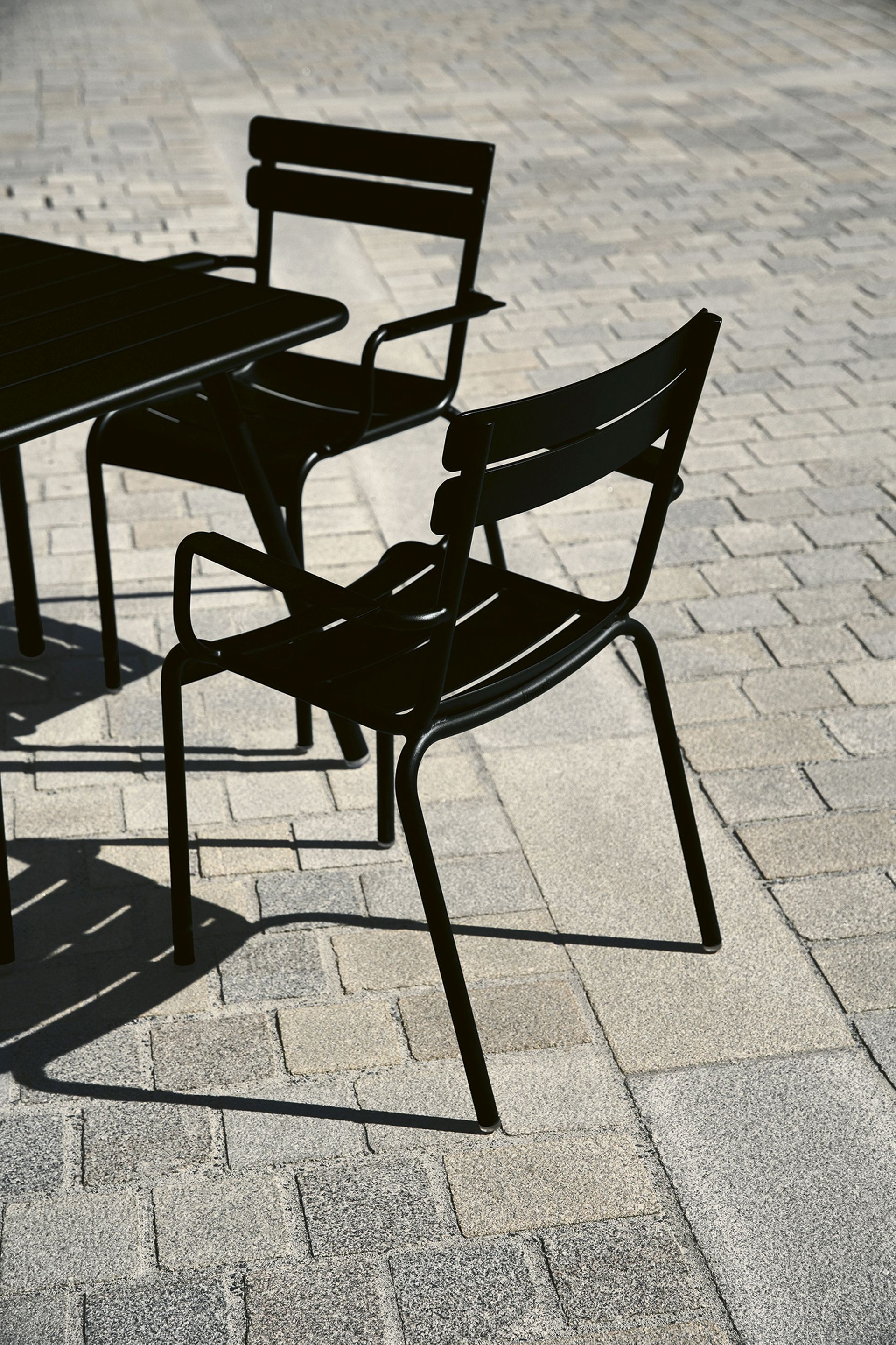 Der LUXEMBOURG Armlehnstuhl von Fermob ist ein stilvoller Metallstuhl, verfügbar in vielen, kräftigen Farben.